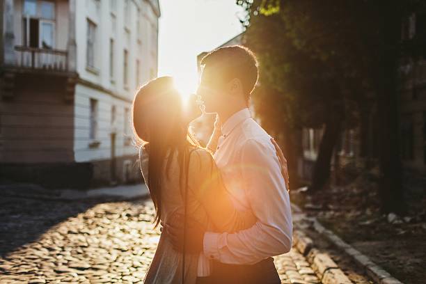 istock Couple kissing in park 609689598