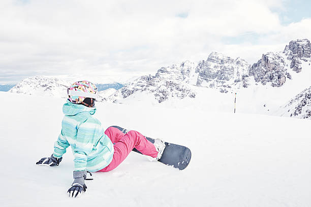 istock Young woman with snowboard 609691696