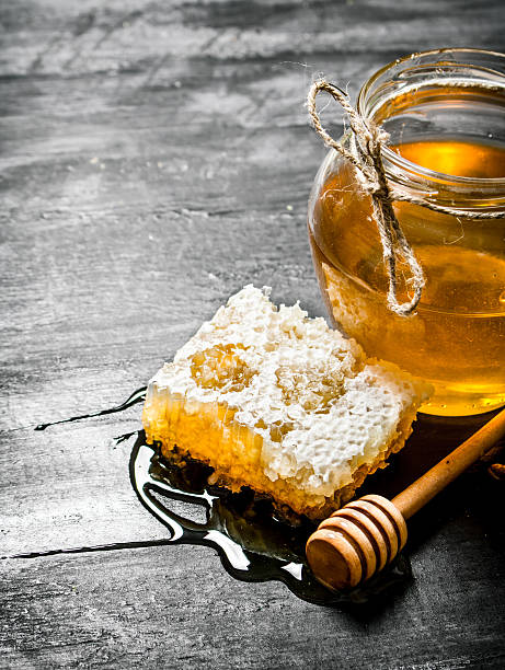 istock Honey background. Natural  comb and a glass jar. 609692172