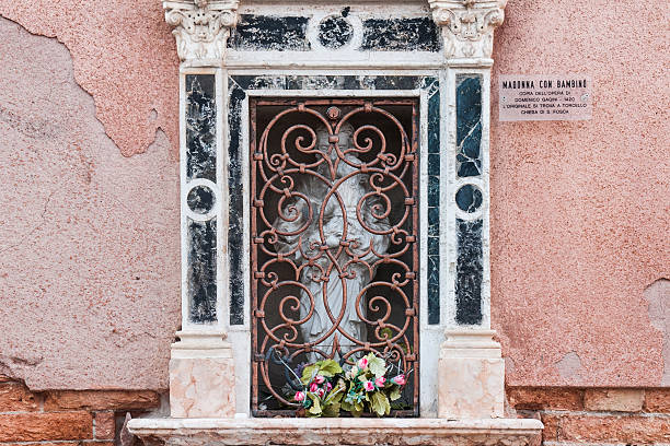 A catholic votive shrine on the wall of the St. Giacomo da l'Orio church in Venice.