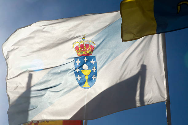 istock Galicia flag fluttering in the wind backlit, clear sky. 609694082