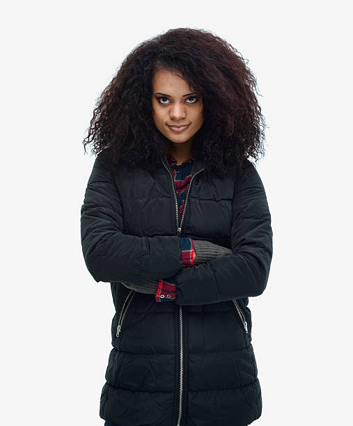 istock Smiling woman standing with arms crossed 609694668