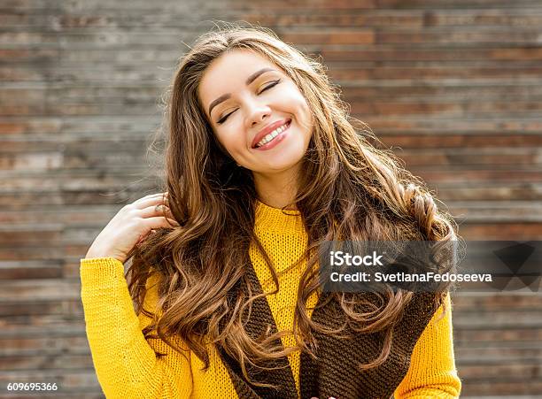 Beautiful Brunette Woman Over Wooden Background Stock Photo - Download Image Now - Autumn, Women, Human Hair