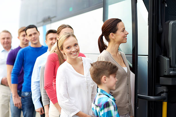 istock group of happy passengers boarding travel bus 609696416