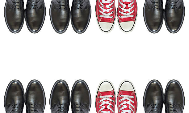 istock red sneakers and man business shoes 609696520