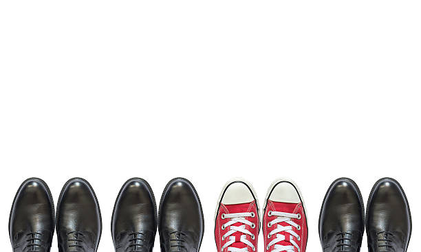 red sneakers and man business shoes