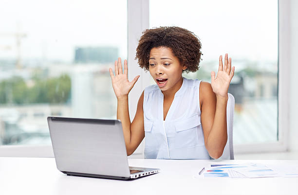 istock african woman with laptop at office 609698114
