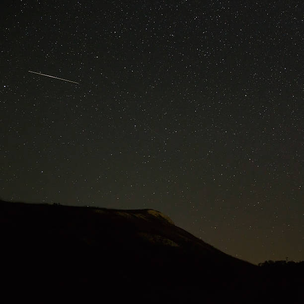 istock Bright meteor over the slope of the mountain 609698380