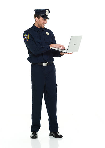 istock Smiling police working on laptop 609699128