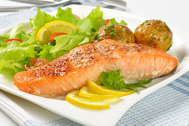 istock salmon fillet with roasted potatoes and fresh vegetables 609699130