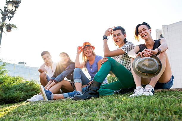 istock Happy friends relaxing on the grass and laughing. 609699292