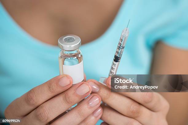 Woman Holding Medicine Bottle And Syringe Stock Photo - Download Image Now - Insulin, Adult, Adults Only