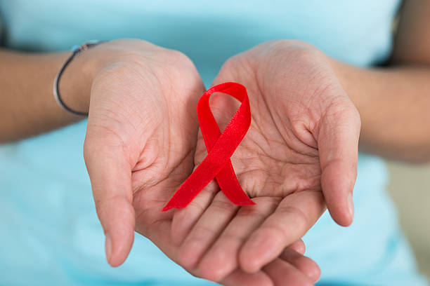 istock Woman Holding Aids Awareness Ribbon 609699582