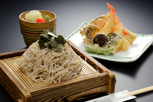 Japanese Udon noodle with seaweed and shrimp tempura on bamboo tray
