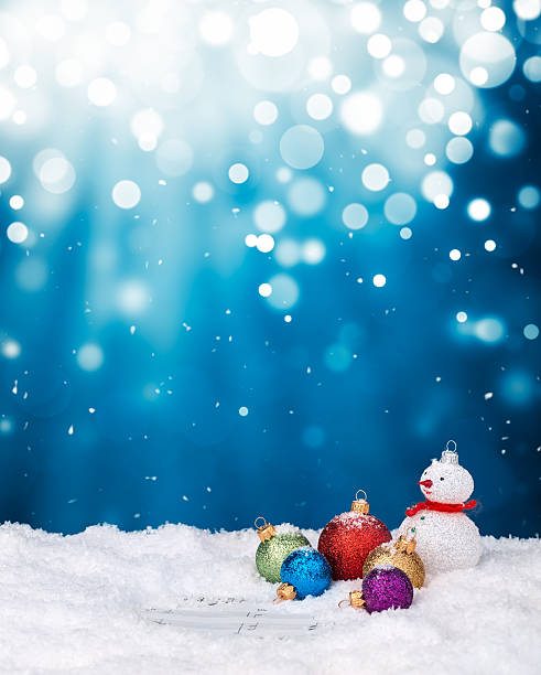 istock Snowman and multicolor baubles on snow 609702166