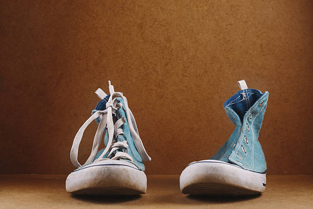 istock One sneaker with lace and one without lace 609703386