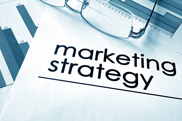 istock Paper with words marketing strategy and charts. 609703596