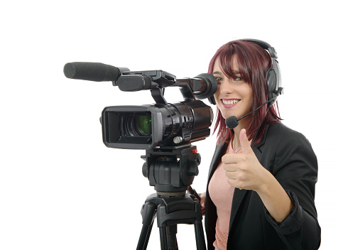 a beautiful young woman with a professional video camera and headphone