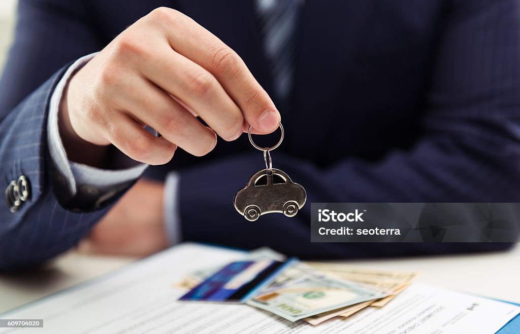 Businessman in the office Male auto dealer selling car to client. Concept of leasing, investment and sale. Shallow depth of field. Adult Stock Photo