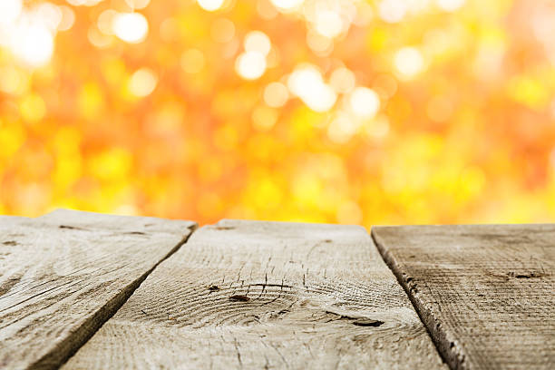 istock Autumn background - wood table and blured trees 609705826