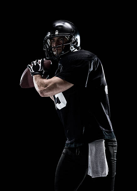 istock American football player holding ball 609705948
