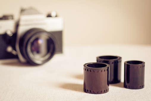 Close up of film rolls with retro photo camera
