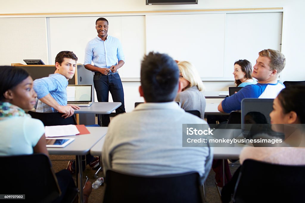 Male Tutor Teaching University Students In Classroom Professor Stock Photo