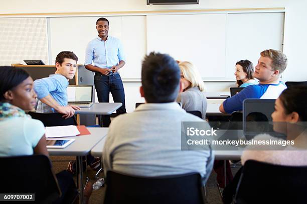 Male Tutor Teaching University Students In Classroom Stock Photo - Download Image Now