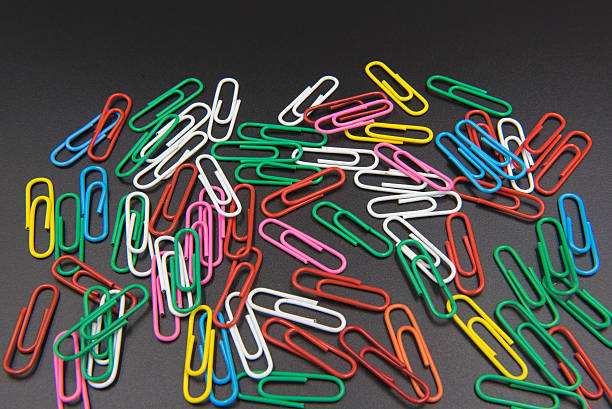 istock Colorful Paper clips isolated on black background. 609707158