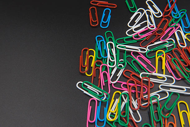 istock Colorful Paper clips isolated on black background. 609707454