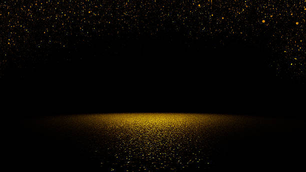 glitzernden golden glitter fallen auf flache oberfläche beleuchtet mit spotlight - gold bright brightly lit light stock-fotos und bilder