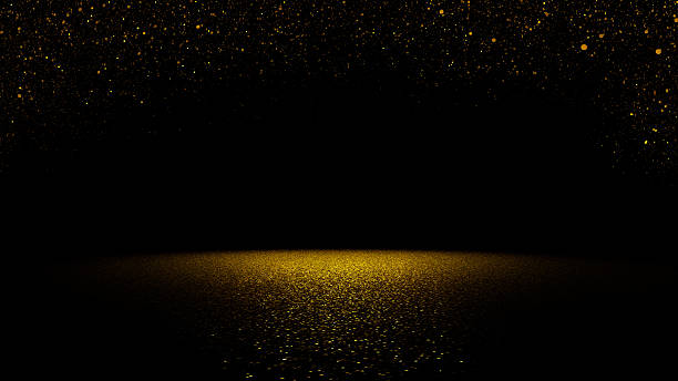 twinkling glitter ouro caindo sobre uma superfície plana iluminada pela luz - black gold imagens e fotografias de stock