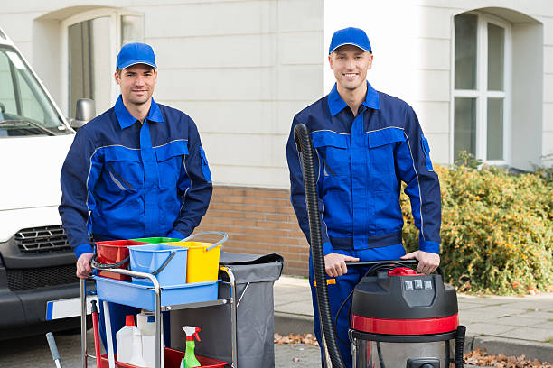 istock Happy Janitors Standing Against Truck 609711540