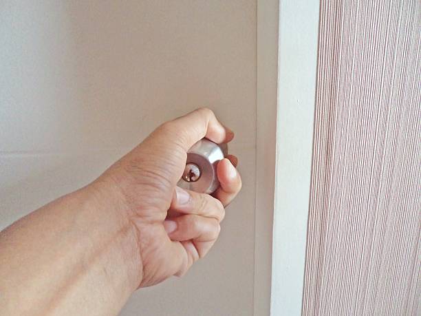 istock Man hand opening door knob 609711992