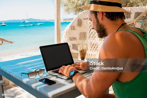 Young Man Working On His Laptop With A Nice View Stock Photo - Download Image Now - Beach, Working, Banking