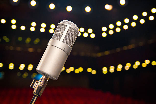 istock Microphone close up in concert hall on stage 609712148