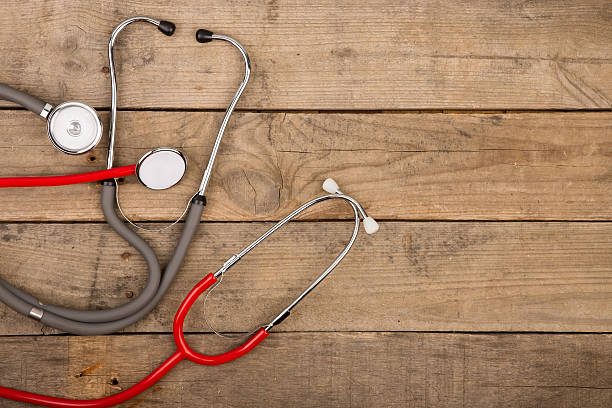 istock Grey and red stethoscopes on wooden desk 609712226