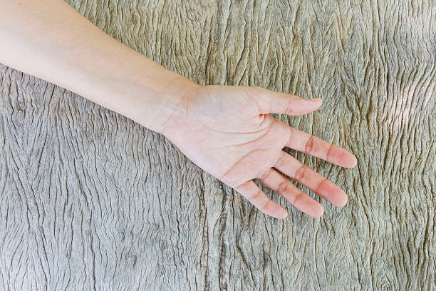 istock Woman hand on wood background. 609714252