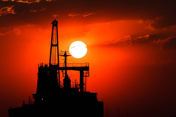 istock Silhouette picture of vessel with sunset. 609718288