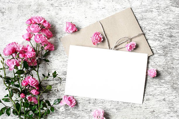 istock Bouquet of roses with a blank greeting card and envelope 609718428