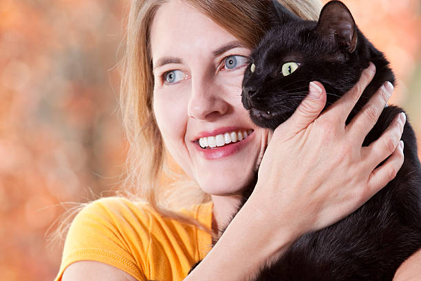 istock Woman Hugging Her Black Cat 609722154