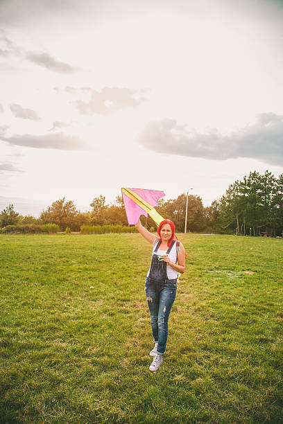 istock Young woman flying a kite 609723672