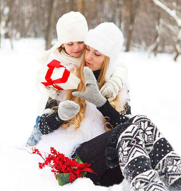 istock Happy young mother and daughter with present 609723962