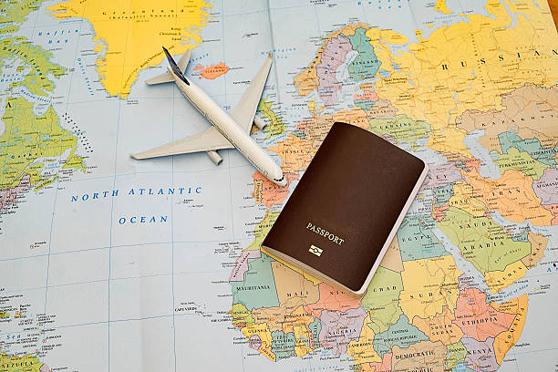 istock passport,toy plane map blackground 609724068