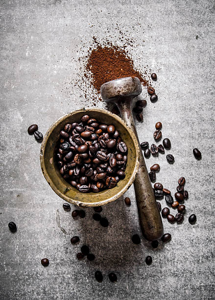 istock Roasted coffee beans in a mortar with pestle. 609725462