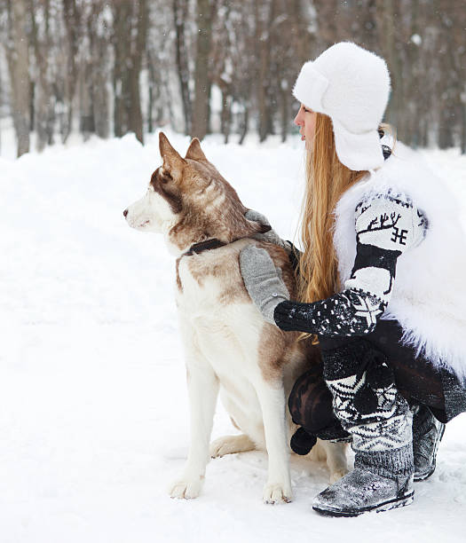 istock Happy young woman with huskies dog 609725874