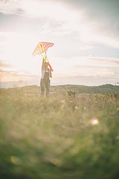 istock Young woman flying a kite 609726332