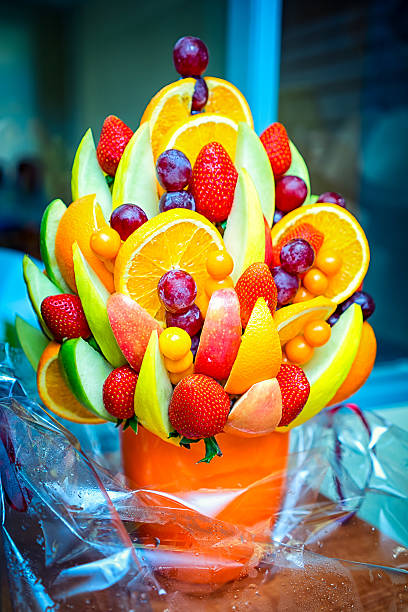Fruit bouquet from grapes, strawberry, and apples Fruit bouquet from grapes, strawberry, and apples arrangement stock pictures, royalty-free photos & images