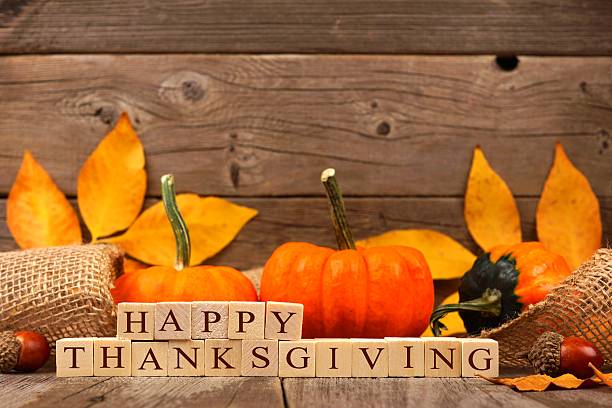 istock Happy Thanksgiving wooden blocks with wood background,pumpkins, leaves 609727574