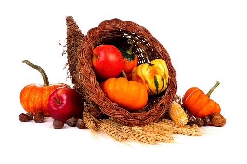 Thanksgiving cornucopia with pumpkins, apples and gourds isolated on a white background